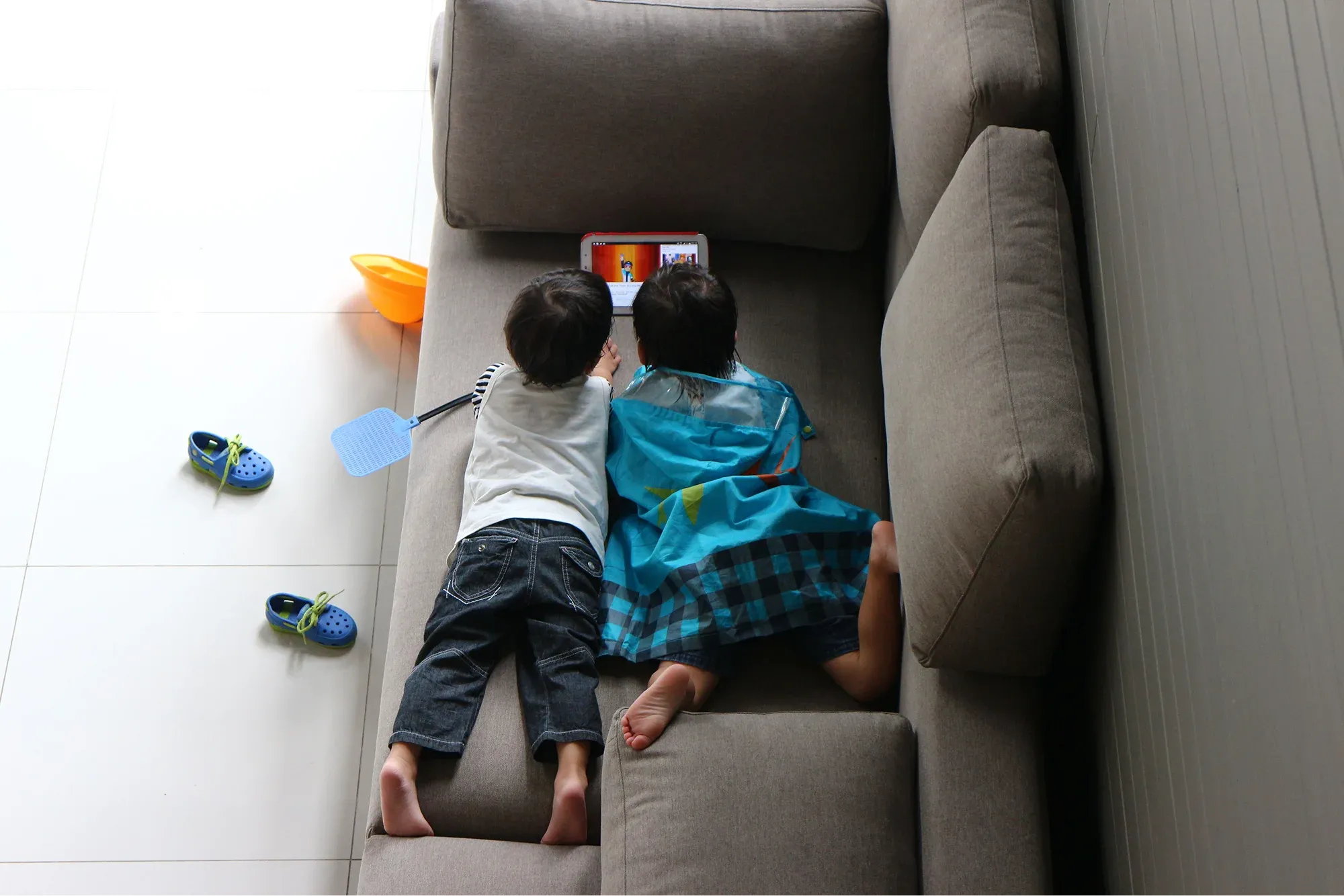 Two kids playing on tablet